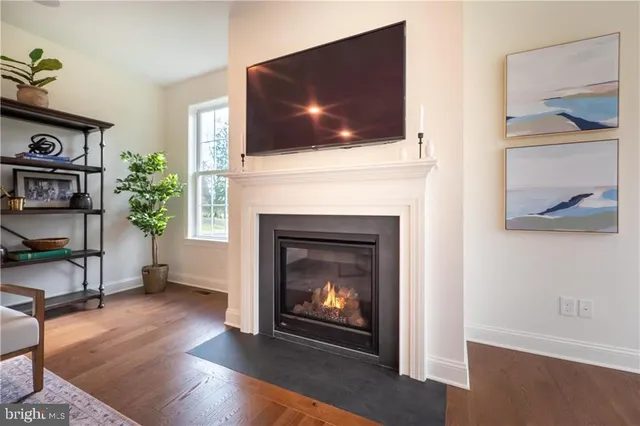 a living room with a fireplace and a flat screen tv