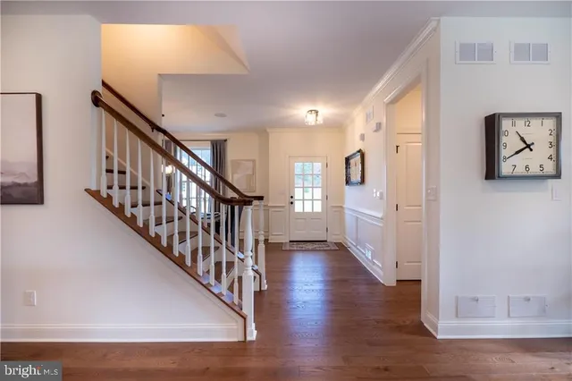 a view of an entryway with wooden floor