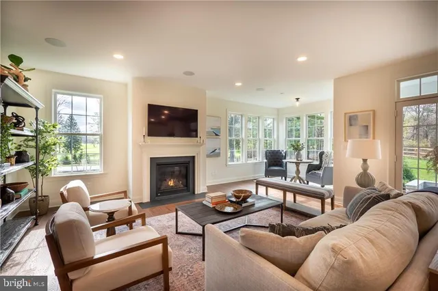 a living room with furniture flat screen tv and a fireplace