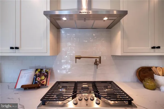 a kitchen with a stove and cabinets