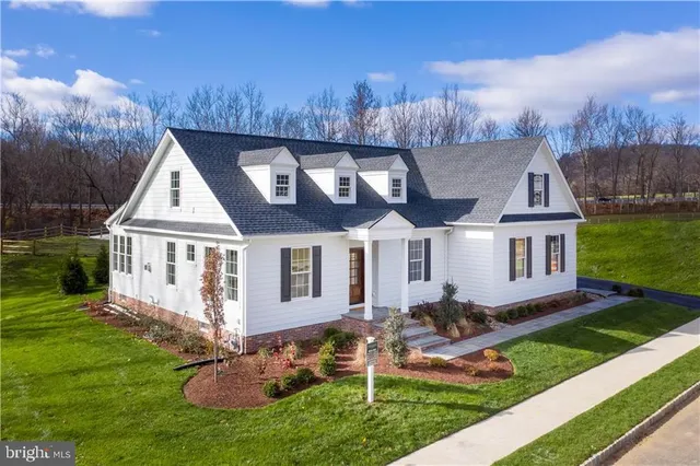 a front view of house with yard and green space