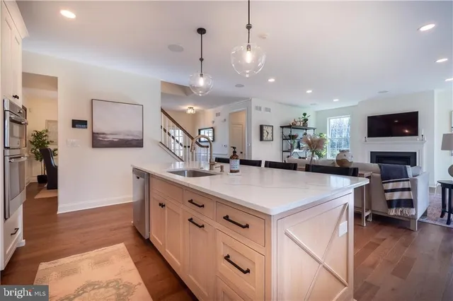 a kitchen with stainless steel appliances kitchen island granite countertop a stove and a sink