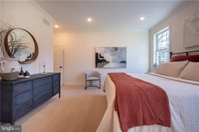 a bed room with a bed mirror and window