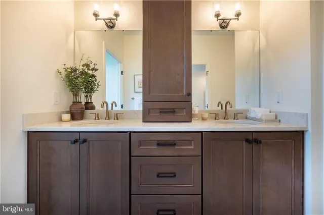 a bathroom with a double vanity sink and a mirror