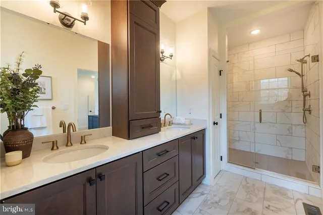 a bathroom with a shower sink and mirror
