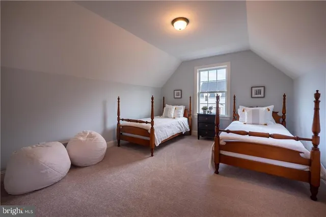 a spacious bedroom with a bed and a couch