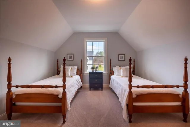 a bedroom with two beds and white walls