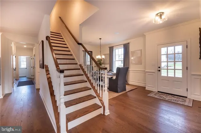 a view of entryway with wooden floor and stairs