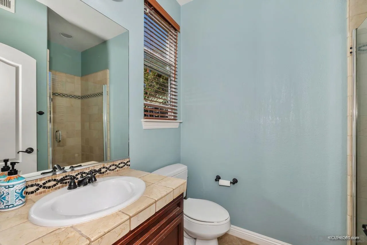 16029 Cayenne Ridge Road San Diego, CA 92127 - Photo 16 of 37 a bathroom with a sink toilet and shower