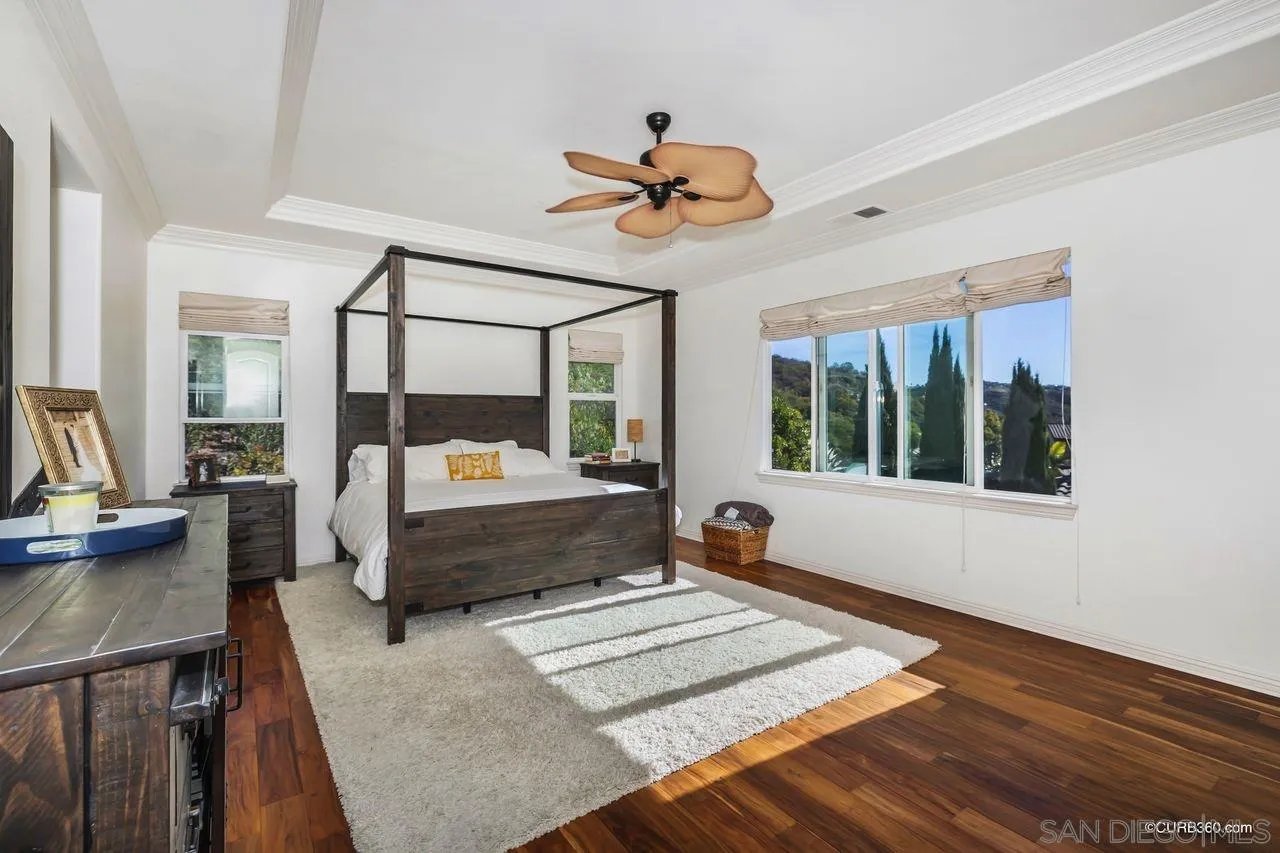 16029 Cayenne Ridge Road San Diego, CA 92127 - Photo 23 of 37 a bedroom with a bed and wooden floor