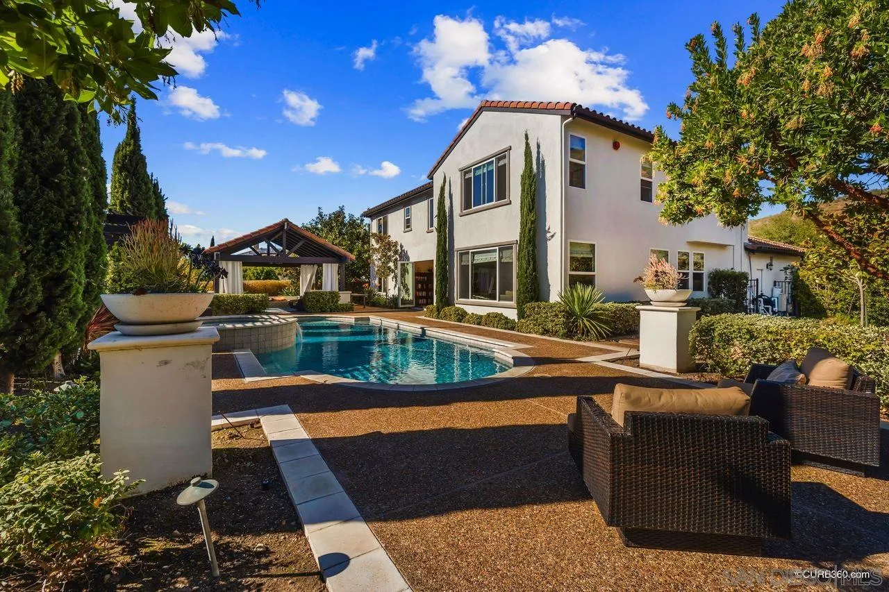 16029 Cayenne Ridge Road San Diego, CA 92127 - Photo 27 of 37 a view of a house with pool and chairs
