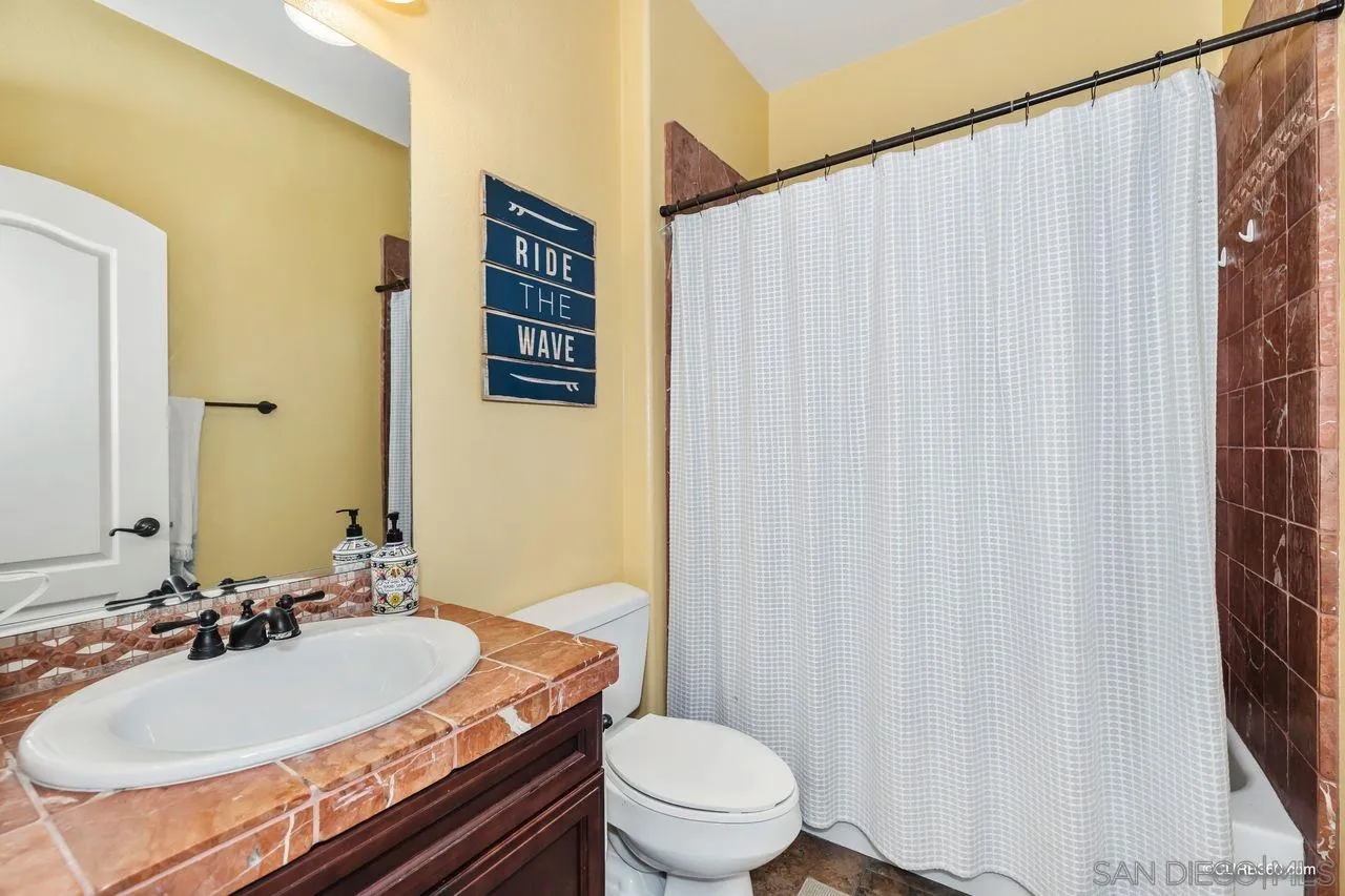 16029 Cayenne Ridge Road San Diego, CA 92127 - Photo 30 of 37 a bathroom with a sink toilet and shower