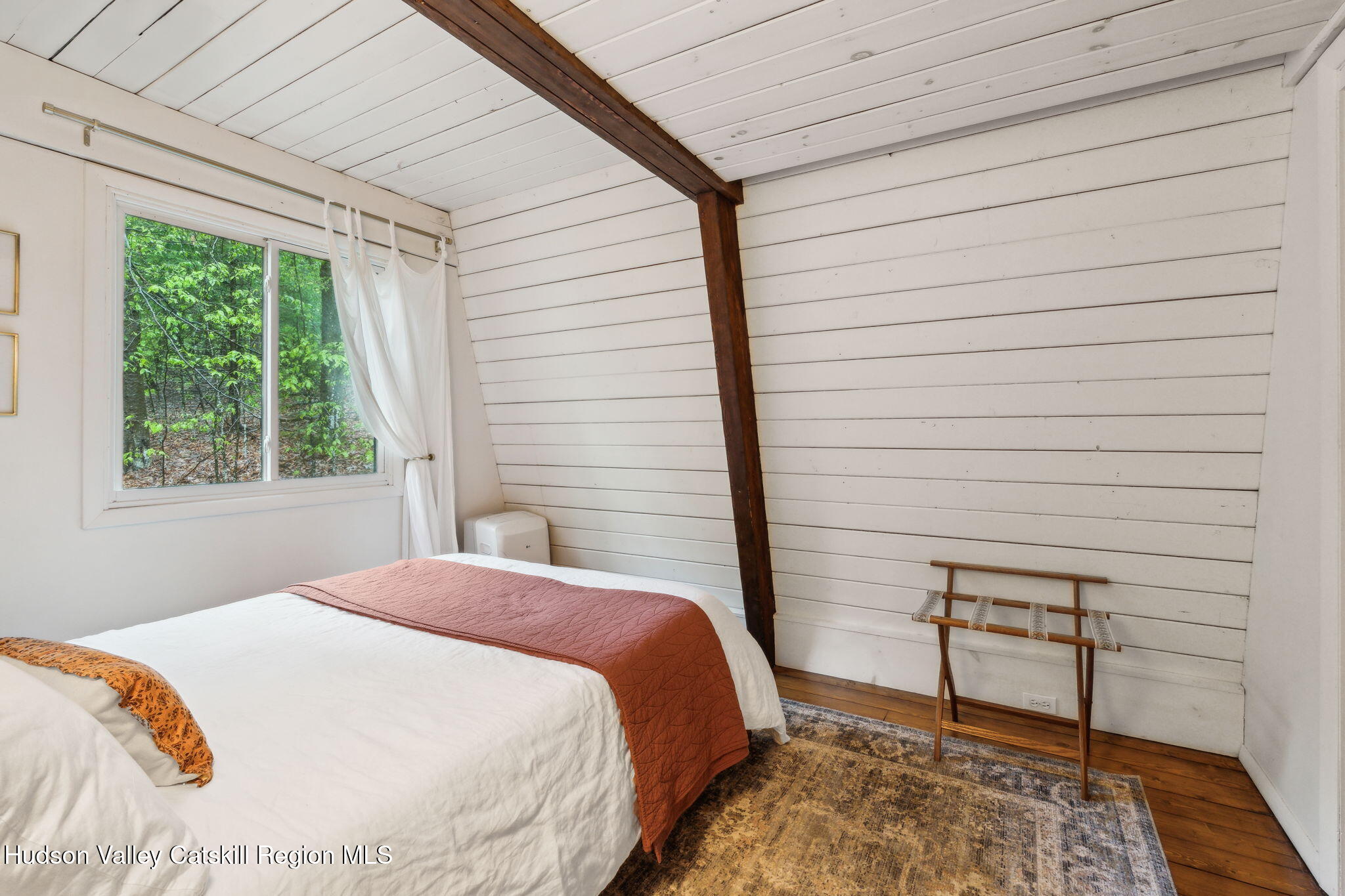 425 North Lake Road Haines Falls, NY 12436 - Photo 28 of 45 a bedroom with a bed and a chair