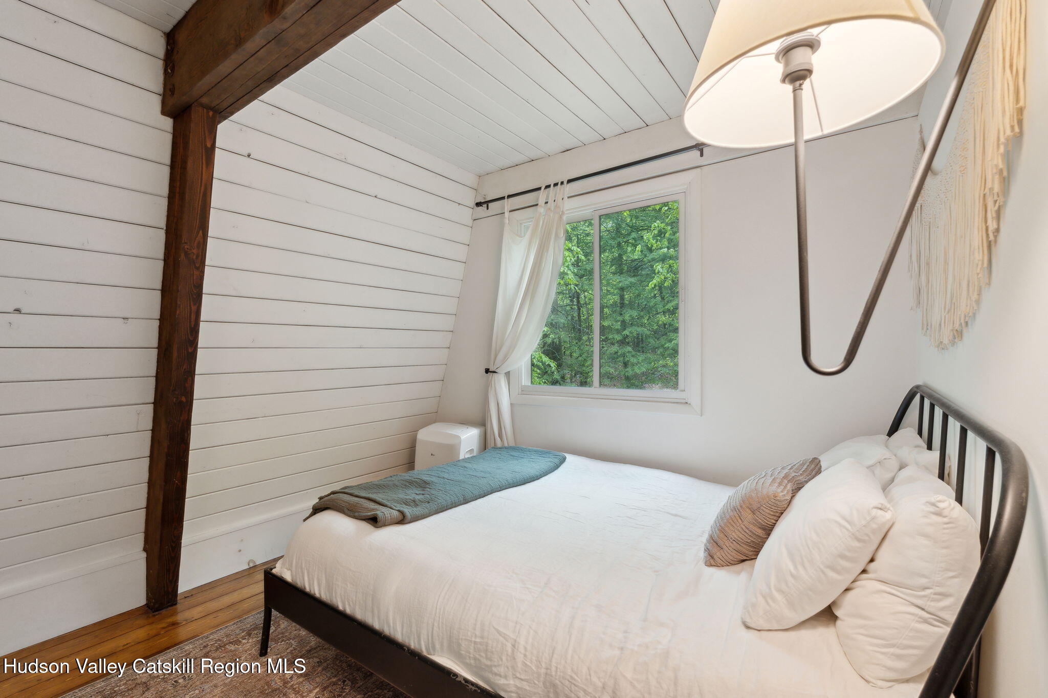 425 North Lake Road Haines Falls, NY 12436 - Photo 30 of 45 a bedroom with a bed a mirror and a window