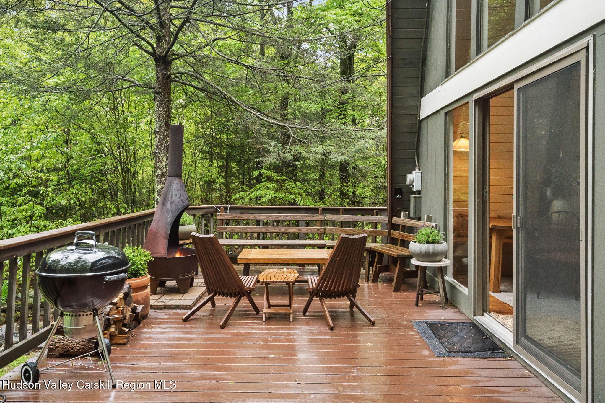 425 North Lake Road Haines Falls, NY 12436 - Photo 32 of 45 a view of a chairs and table on the deck with wooden floor