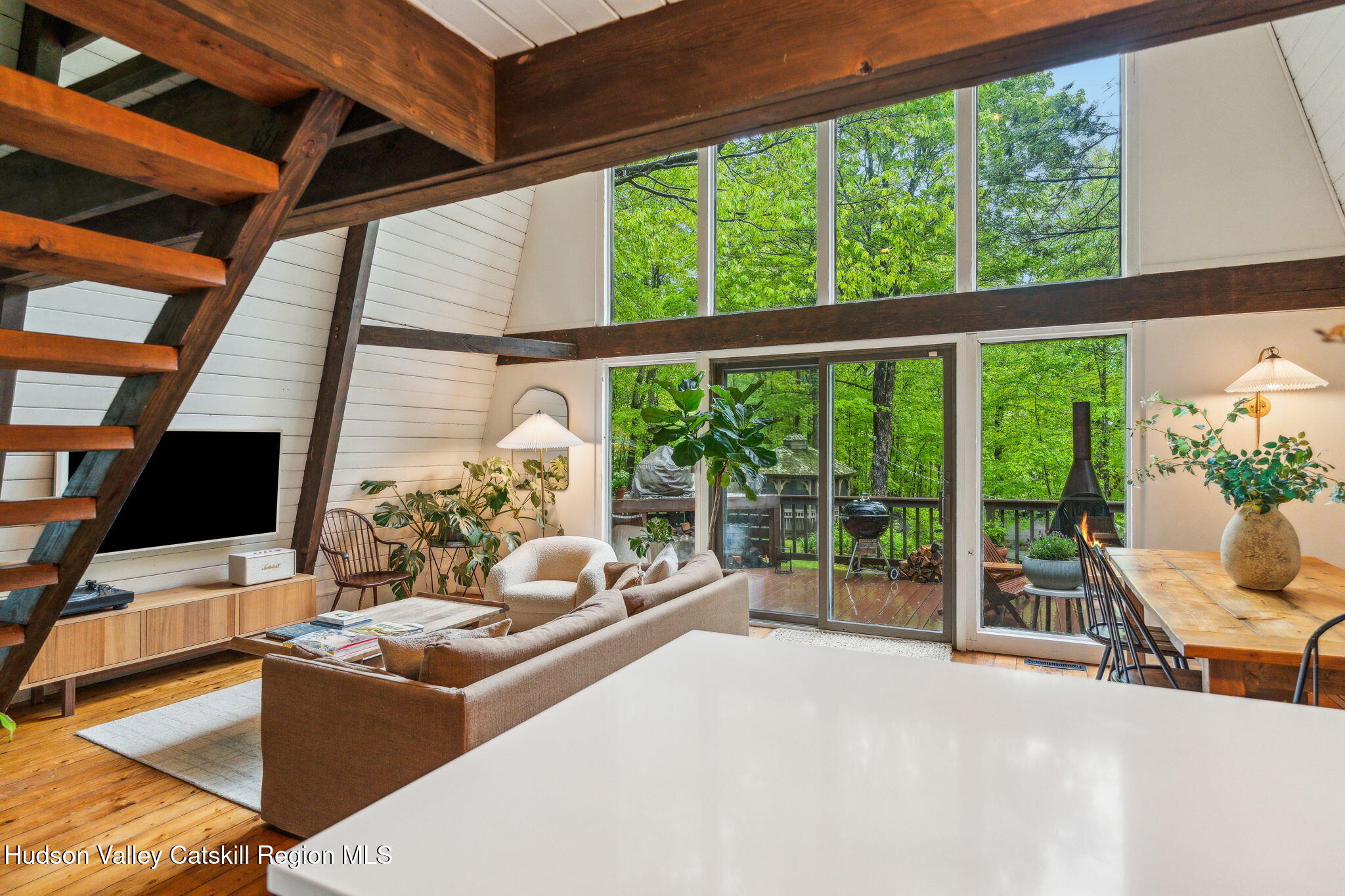 425 North Lake Road Haines Falls, NY 12436 - Photo 9 of 45 a living room with furniture tv and a floor to ceiling window