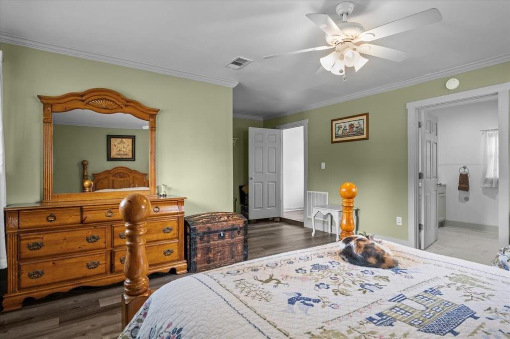 203 Main Street Rosebud, TX 76570 - Photo 13 of 35 a bedroom with a bed and a mirror on the dresser