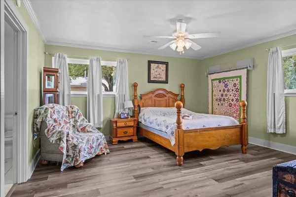 a bedroom with a bed and a mirror on the dresser