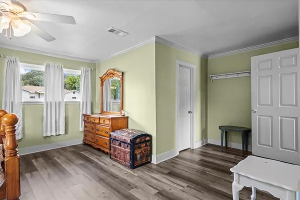 a bedroom with a bed next to a window