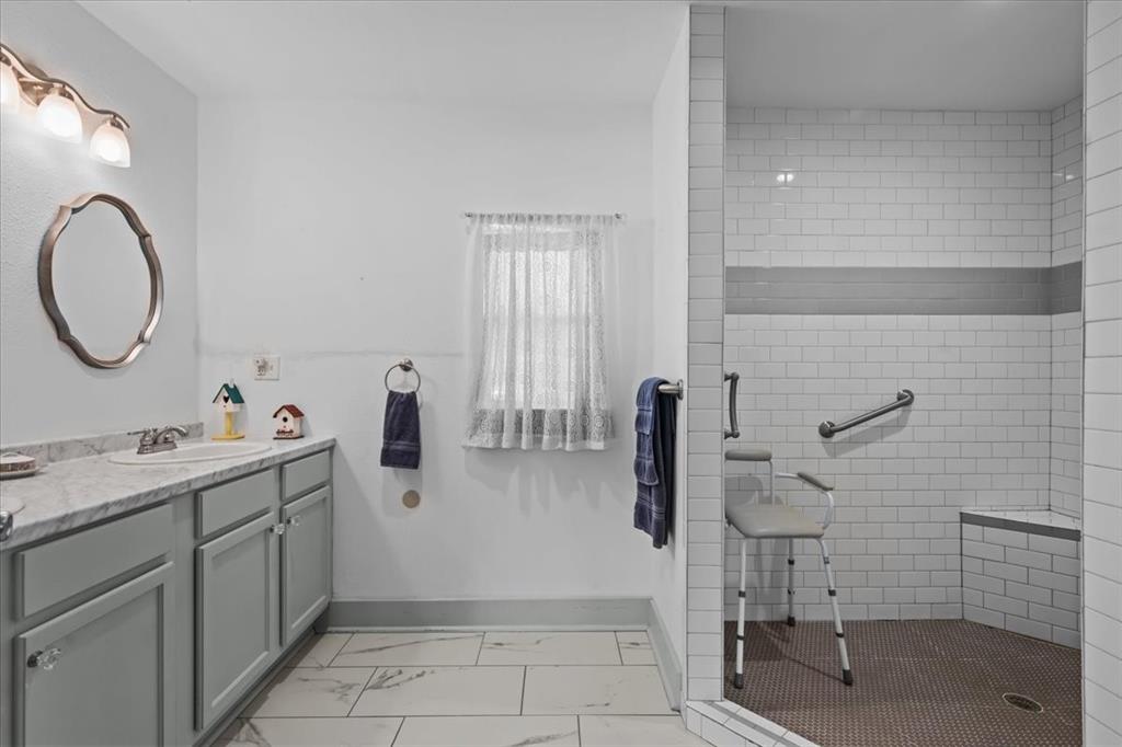 203 Main Street Rosebud, TX 76570 - Photo 19 of 35 a bathroom with a sink and mirror
