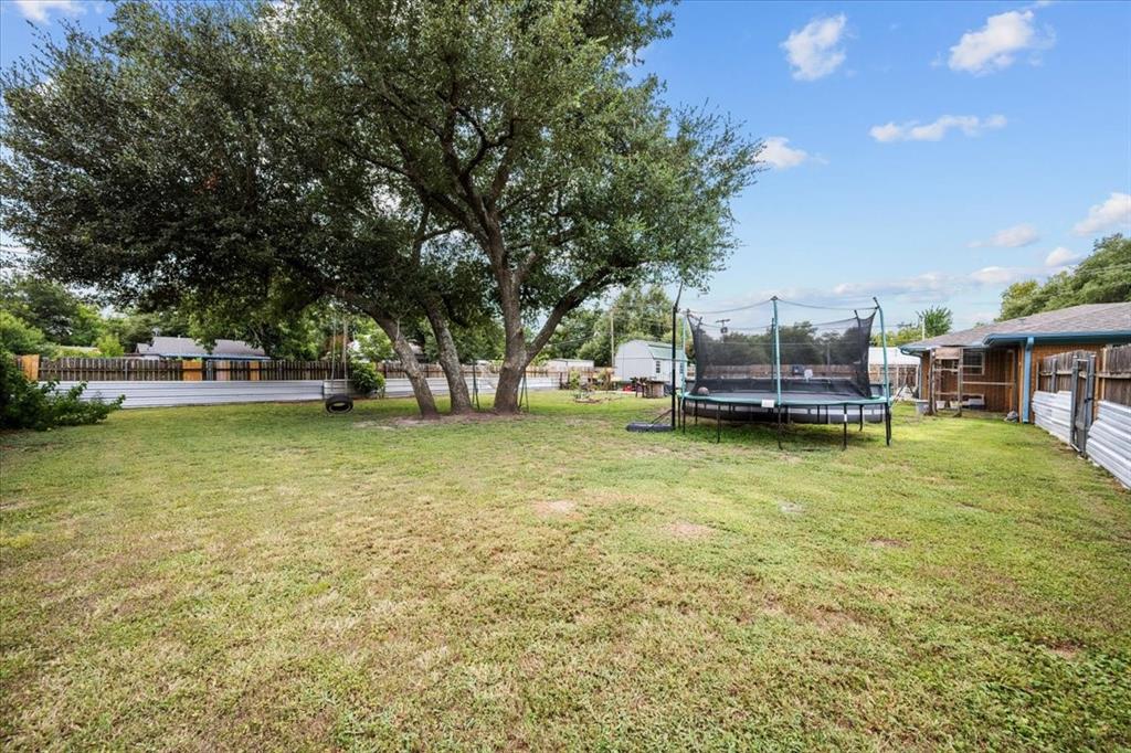 203 Main Street Rosebud, TX 76570 - Photo 2 of 35 a view of a swimming pool with lawn chairs and plants