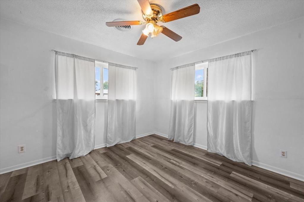 203 Main Street Rosebud, TX 76570 - Photo 20 of 35 an empty room with windows and fan