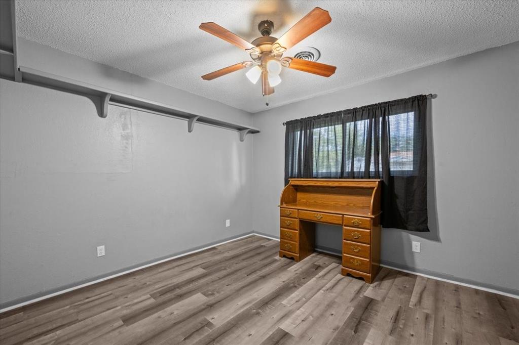 203 Main Street Rosebud, TX 76570 - Photo 22 of 35 a view of room with a ceiling fan and wooden floor