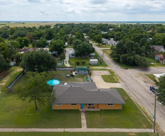 an aerial view of a house with a swimming pool yard and outdoor seating