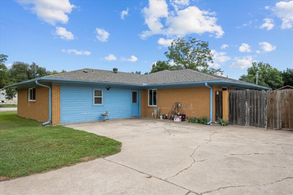 203 Main Street Rosebud, TX 76570 - Photo 30 of 35 a front view of a house with a yard and garage