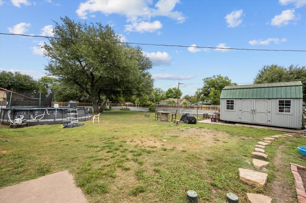 203 Main Street Rosebud, TX 76570 - Photo 31 of 35 a view of a swimming pool with an outdoor seating and a garden
