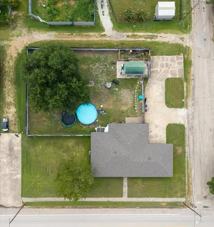 an aerial view of a house with a yard