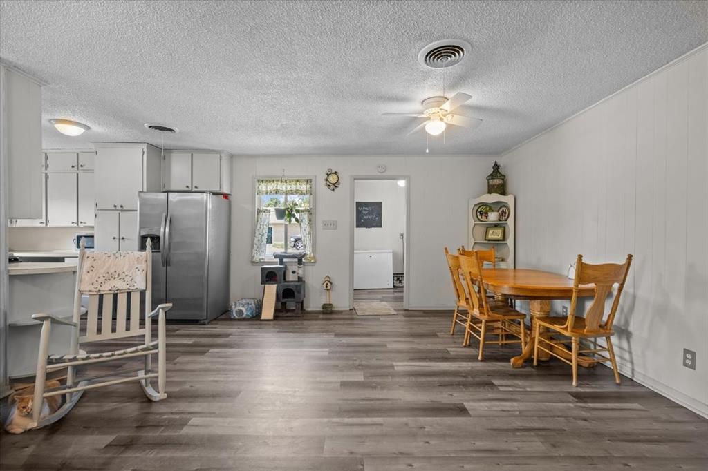 203 Main Street Rosebud, TX 76570 - Photo 7 of 35 a view of a dining room with furniture and a chandelier