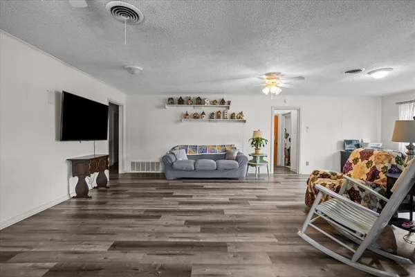 a view of a dining room with furniture and a chandelier