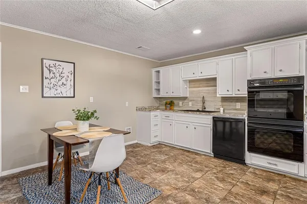 a kitchen with a table and chairs in it