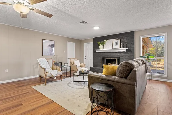 a living room with furniture a fireplace and a flat screen tv