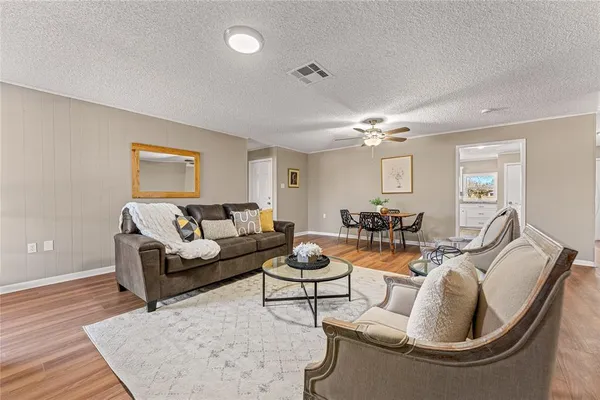 a living room with fireplace furniture and a wooden floor