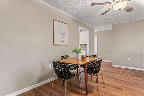 a view of a dining room with furniture and wooden floor