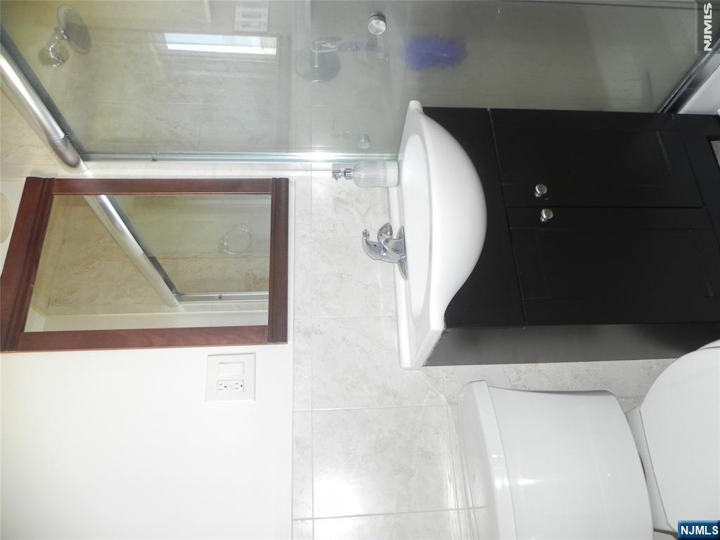52 Wilson Street, Unit 2 Little Ferry, NJ 07643 - Photo 8 of 11 a bathroom with a sink a toilet and bathtub