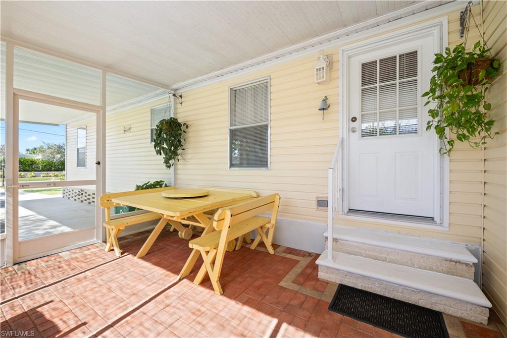 903 Manatee Road Naples, FL 34114 - Photo 4 of 29 a balcony with table and chairs
