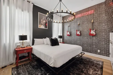 a bedroom with a bed and a chandelier