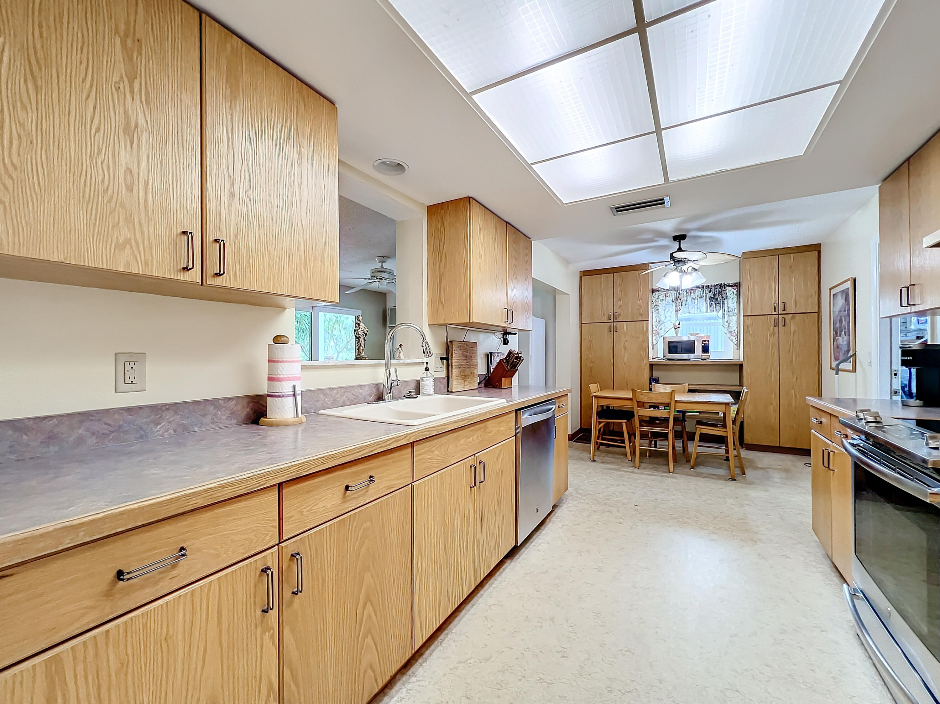502 Circle East Jupiter, FL 33458 - Photo 14 of 55 a kitchen with sink cabinets and outdoor view