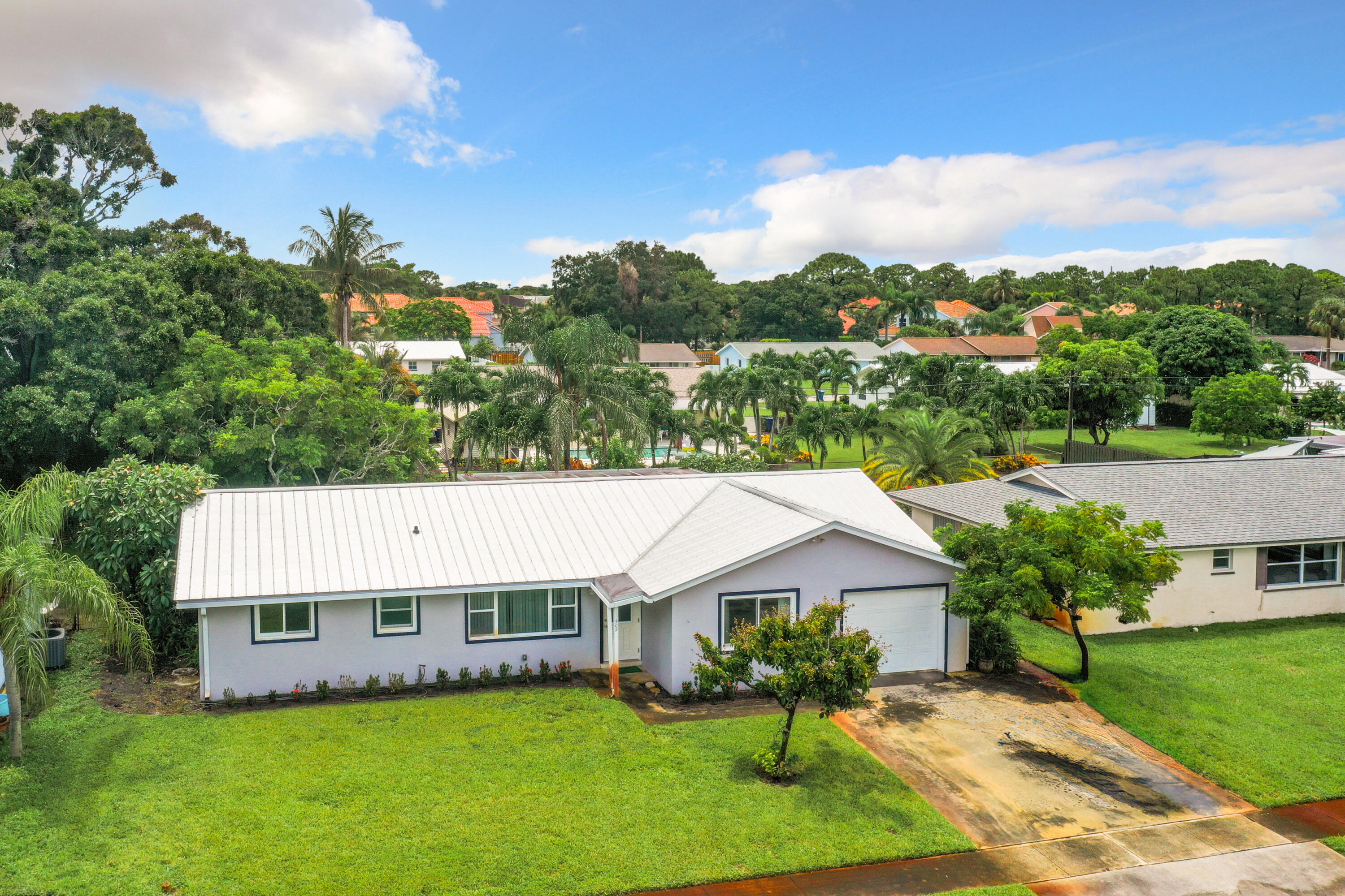 502 Circle East Jupiter, FL 33458 - Photo 2 of 55 an aerial view of a house with a garden and lake view