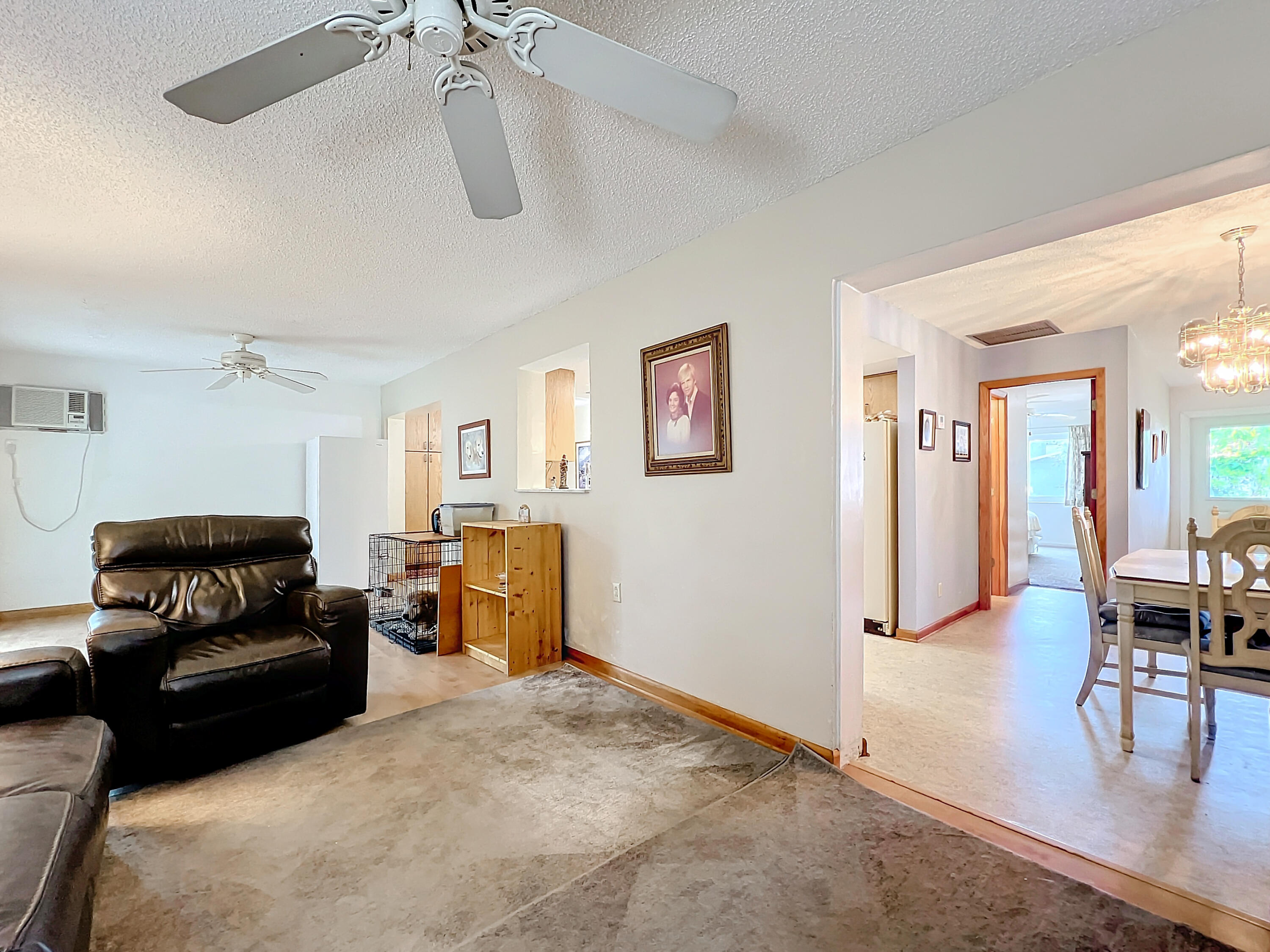 502 Circle East Jupiter, FL 33458 - Photo 26 of 55 a living room with furniture and a dining table with the kitchen view