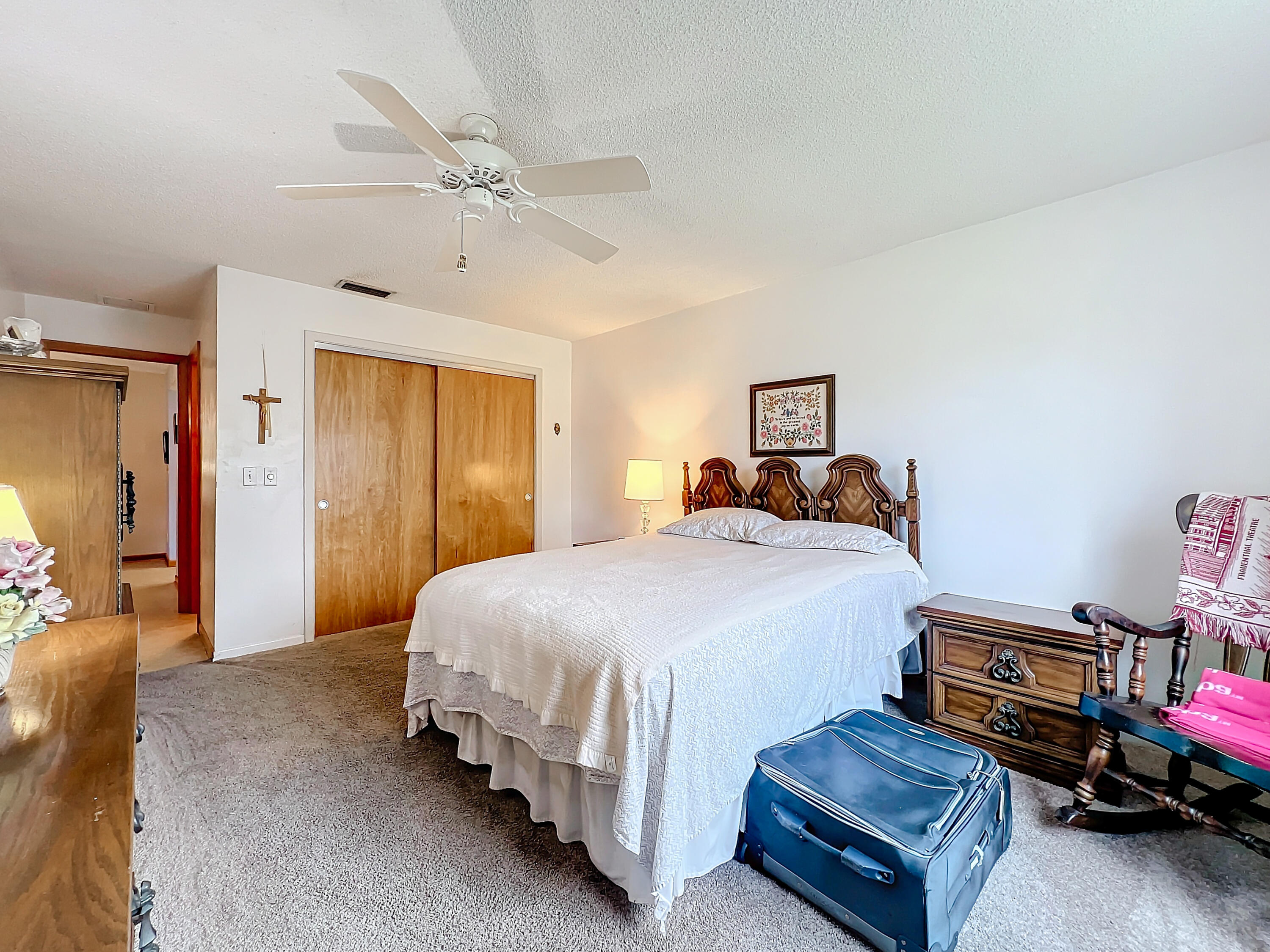 502 Circle East Jupiter, FL 33458 - Photo 34 of 55 a spacious bedroom with a bed and a chandelier