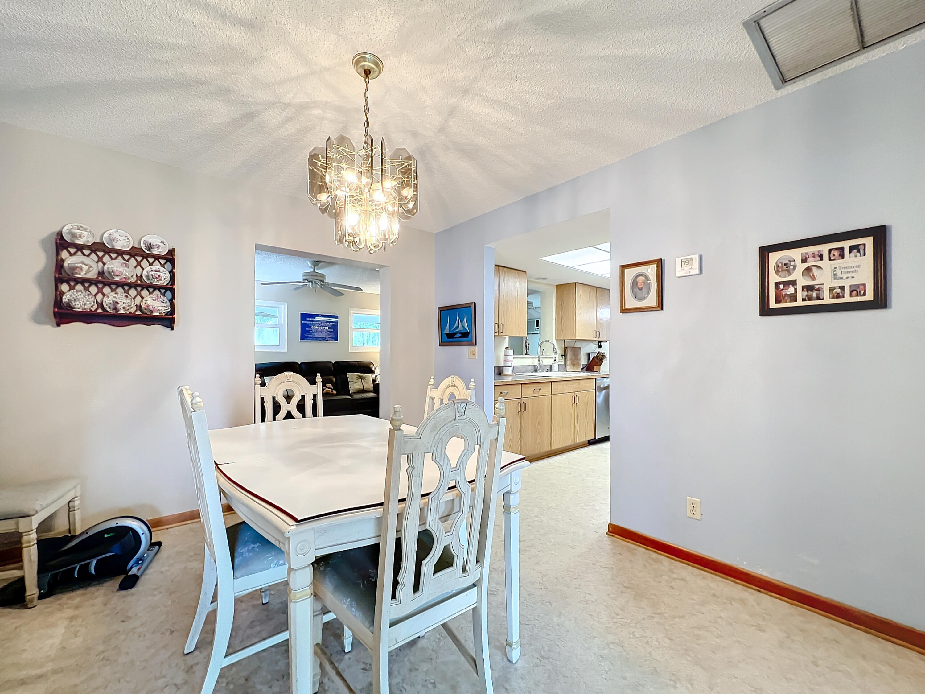 502 Circle East Jupiter, FL 33458 - Photo 10 of 55 a view of a dining room with furniture and a chandelier