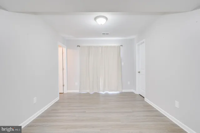 a view of room with wooden floor