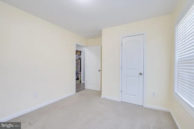 a view of an empty room and closet area