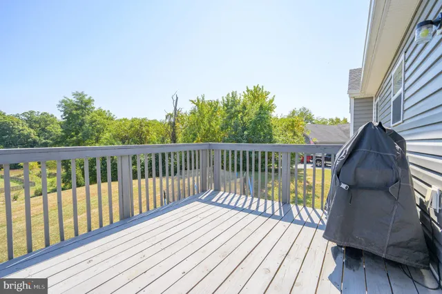 a balcony with wooden floor and fence