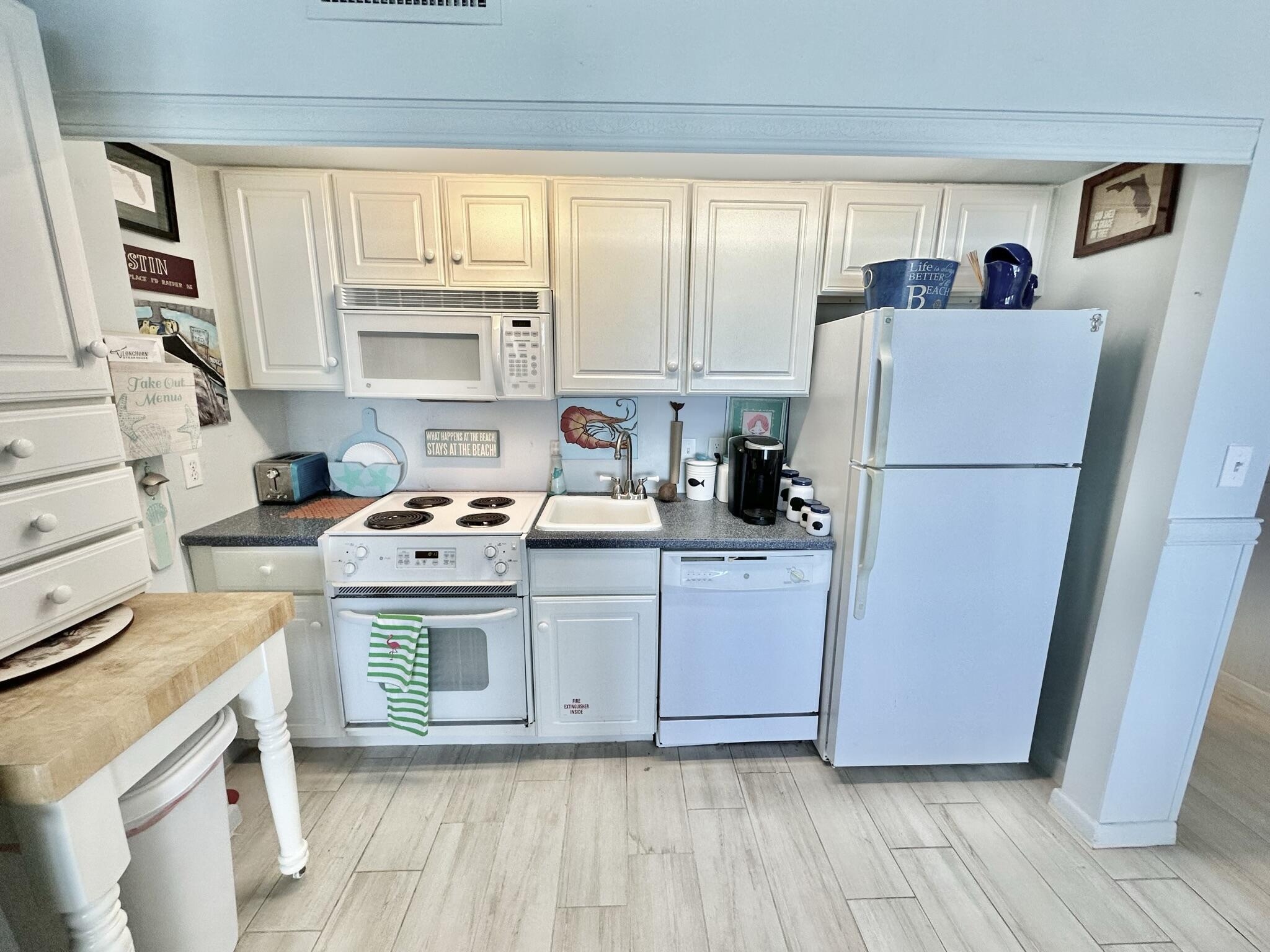 4280 Beachside 2, Unit 280 Miramar Beach, FL 32550 - Photo 12 of 34 a kitchen with a refrigerator sink and cabinets