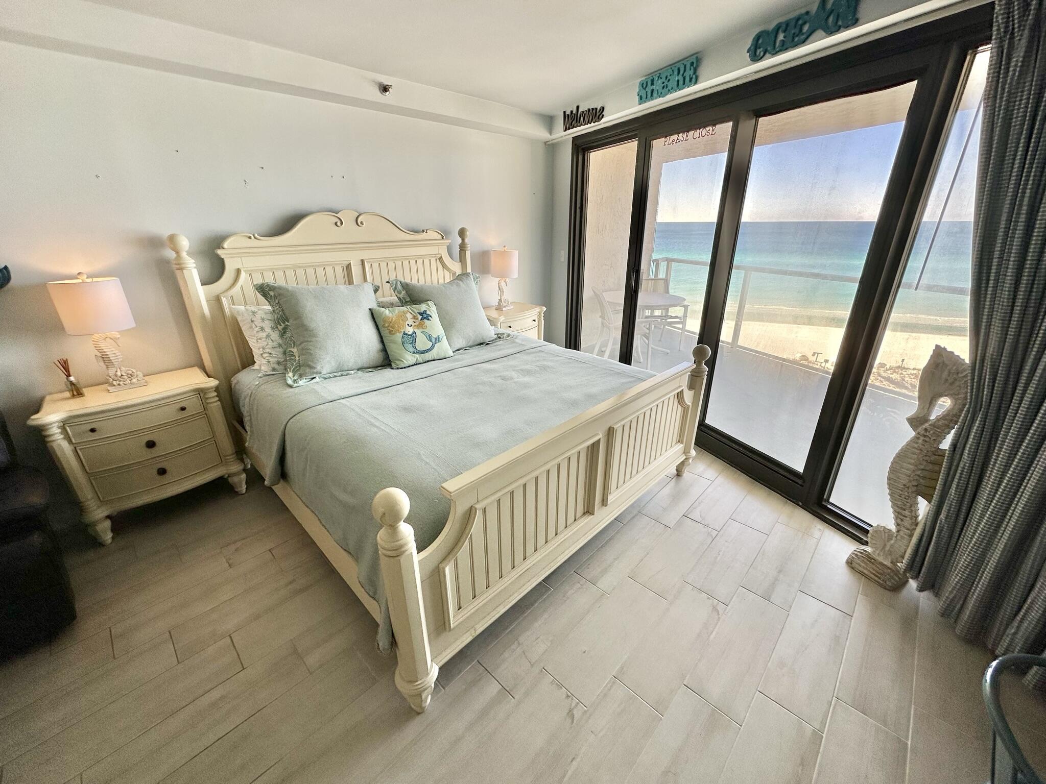 4280 Beachside 2, Unit 280 Miramar Beach, FL 32550 - Photo 22 of 34 a bedroom with a bed next to a large window